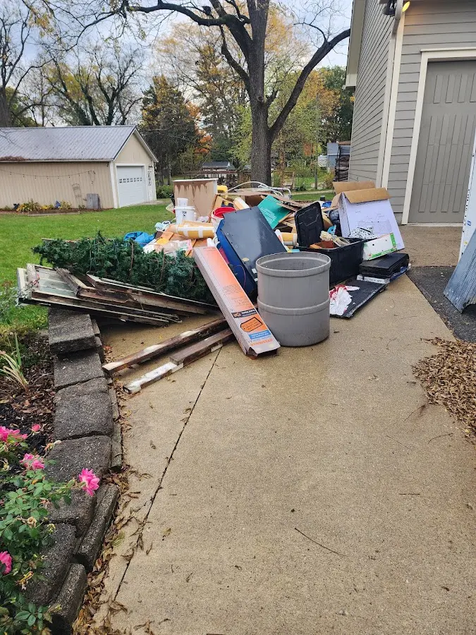 Dumpster being loaded with debris for Estate Cleanout Dumpster Rental in Ensley